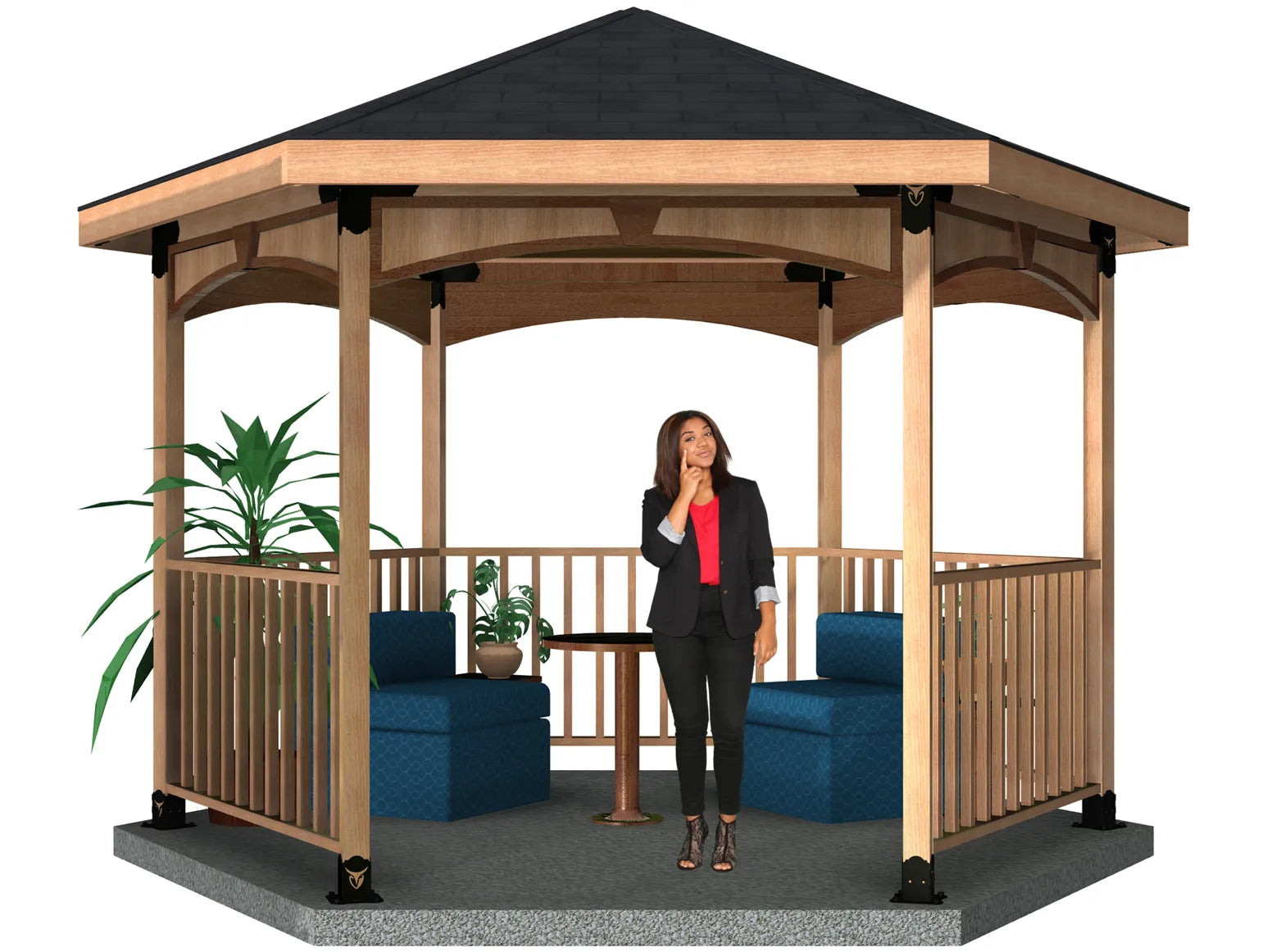 A woman stands inside a spacious wooden gazebo, giving a thumbs up while surrounded by cozy chairs, a table, and a bar. It’s a beautiful day outdoors.