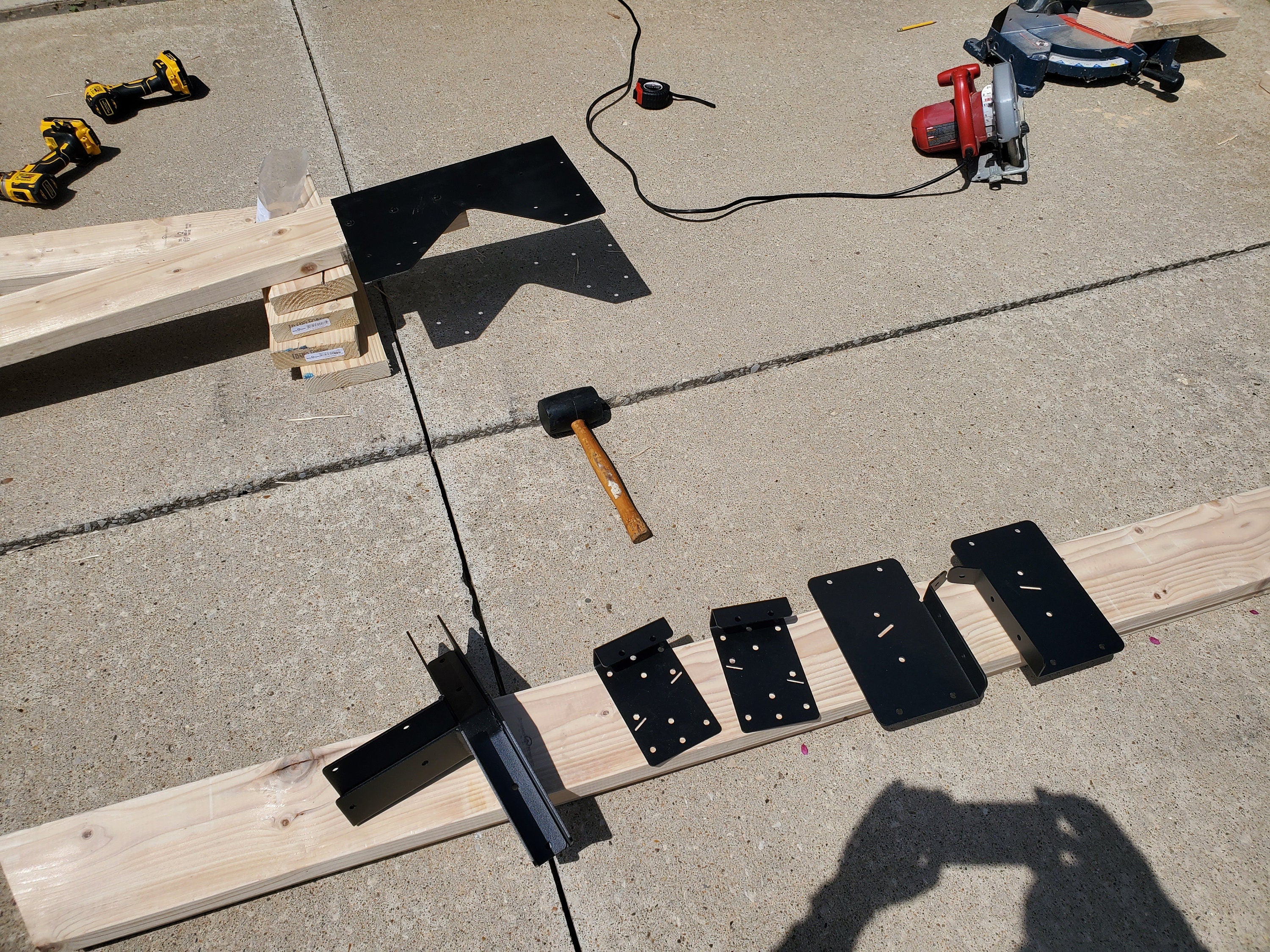 parts of a truss bracket kit laid on the ground