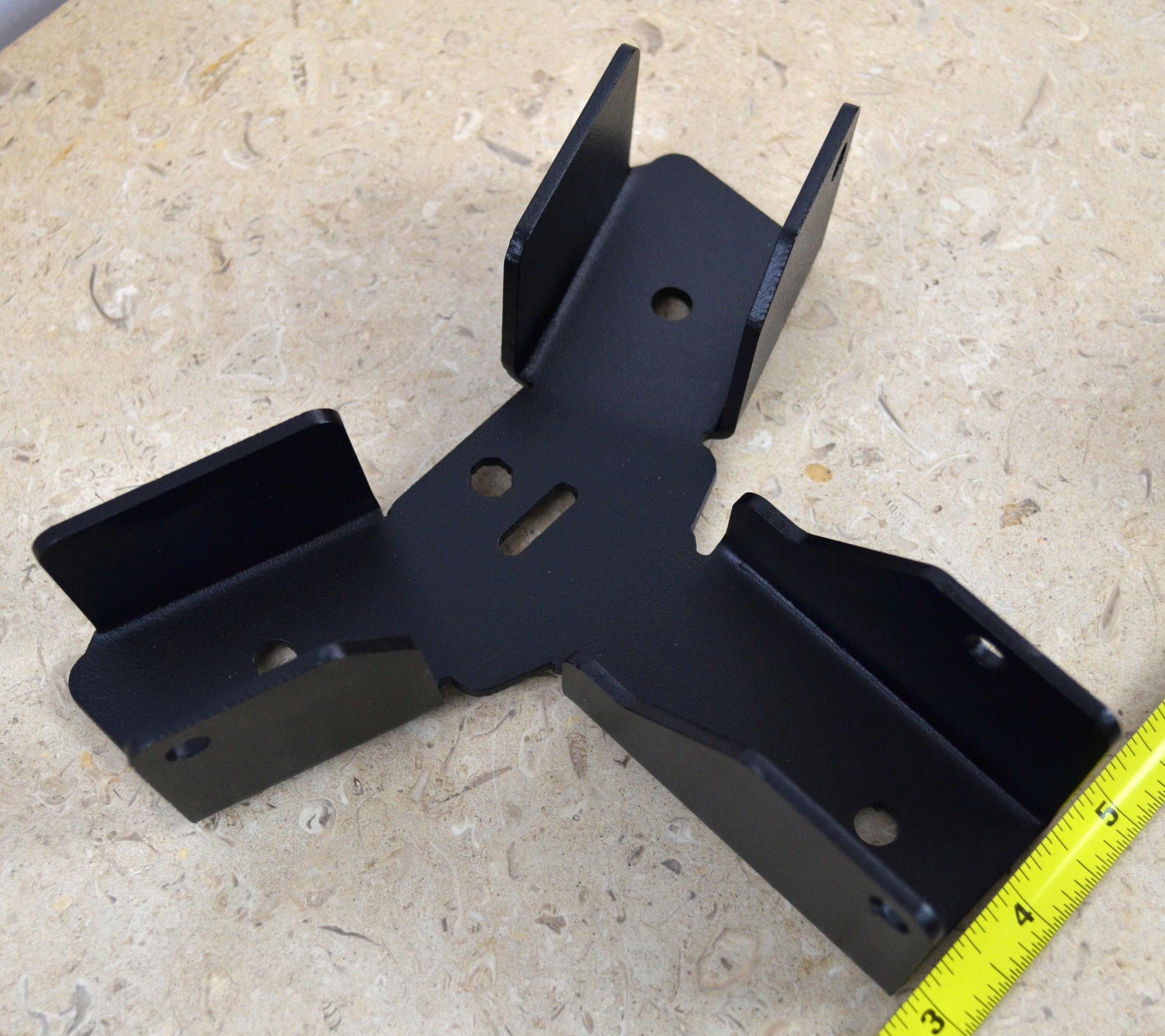 The sturdy hexagon crosstie bracket is arranged on a workbench, showcasing its versatile design for securely mounting fixtures in various construction and DIY tasks.