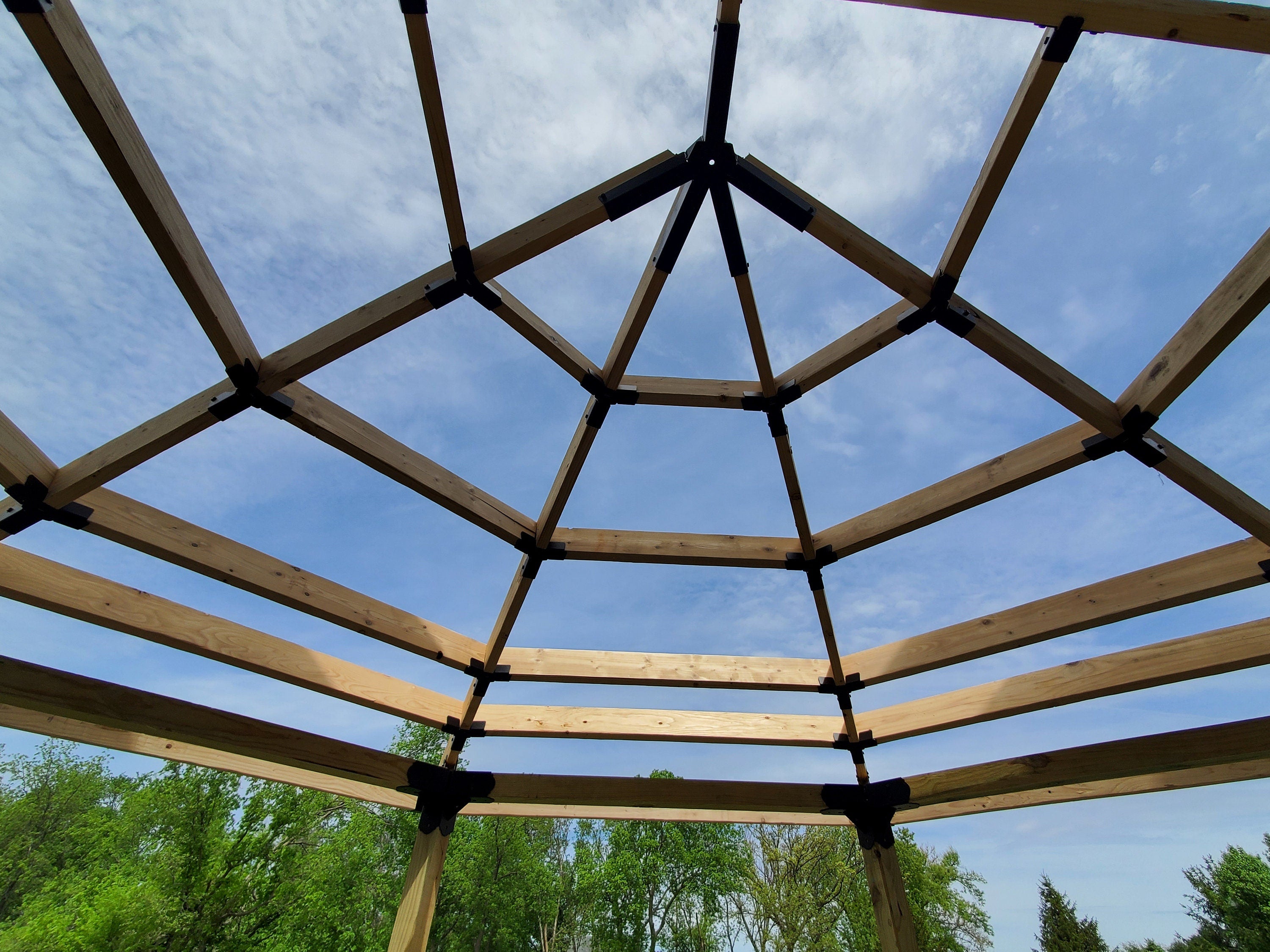 roof frame under construction showing lumber members attached using post top elbows, octagon crosstie brackets, and a partial octagon spider bracket