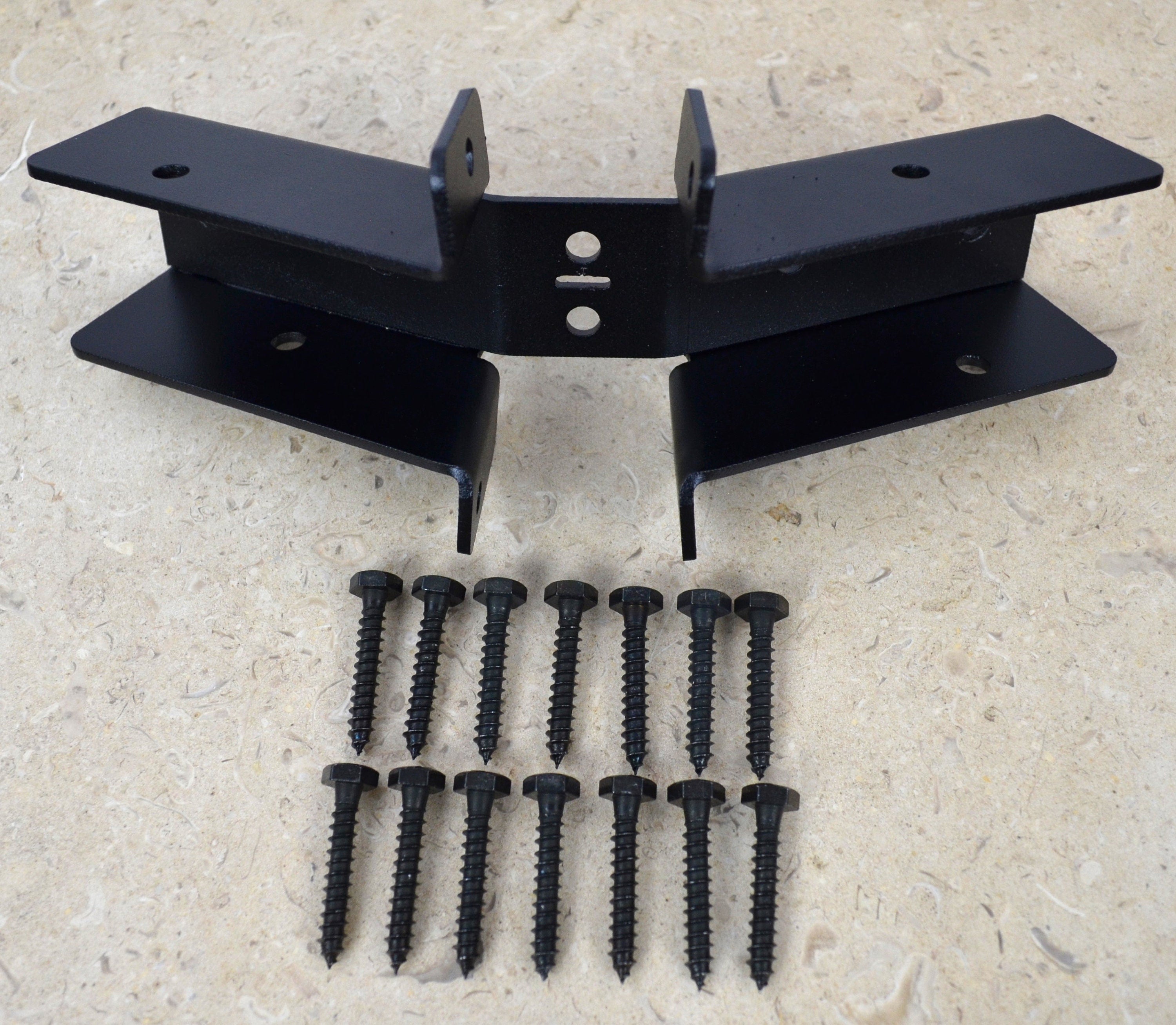 The image shows a partial hexagon ridge rafter tie bracket along with a set of lag screws, essential for enhancing the structural integrity of roofs in construction.