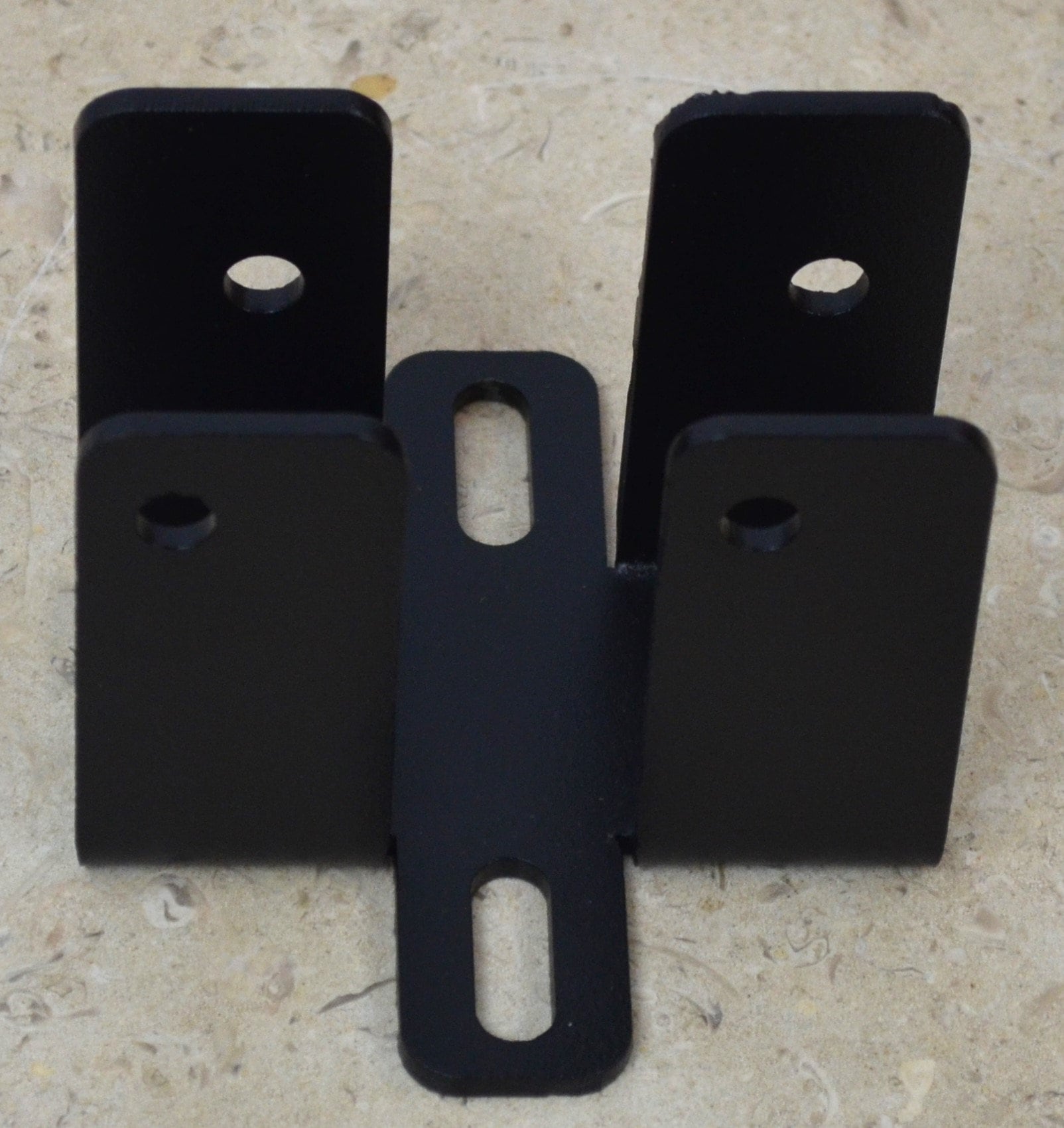 The black metal bracket features multiple holes for easy attachment and stability, making it ideal for construction, renovations, and DIY activities.