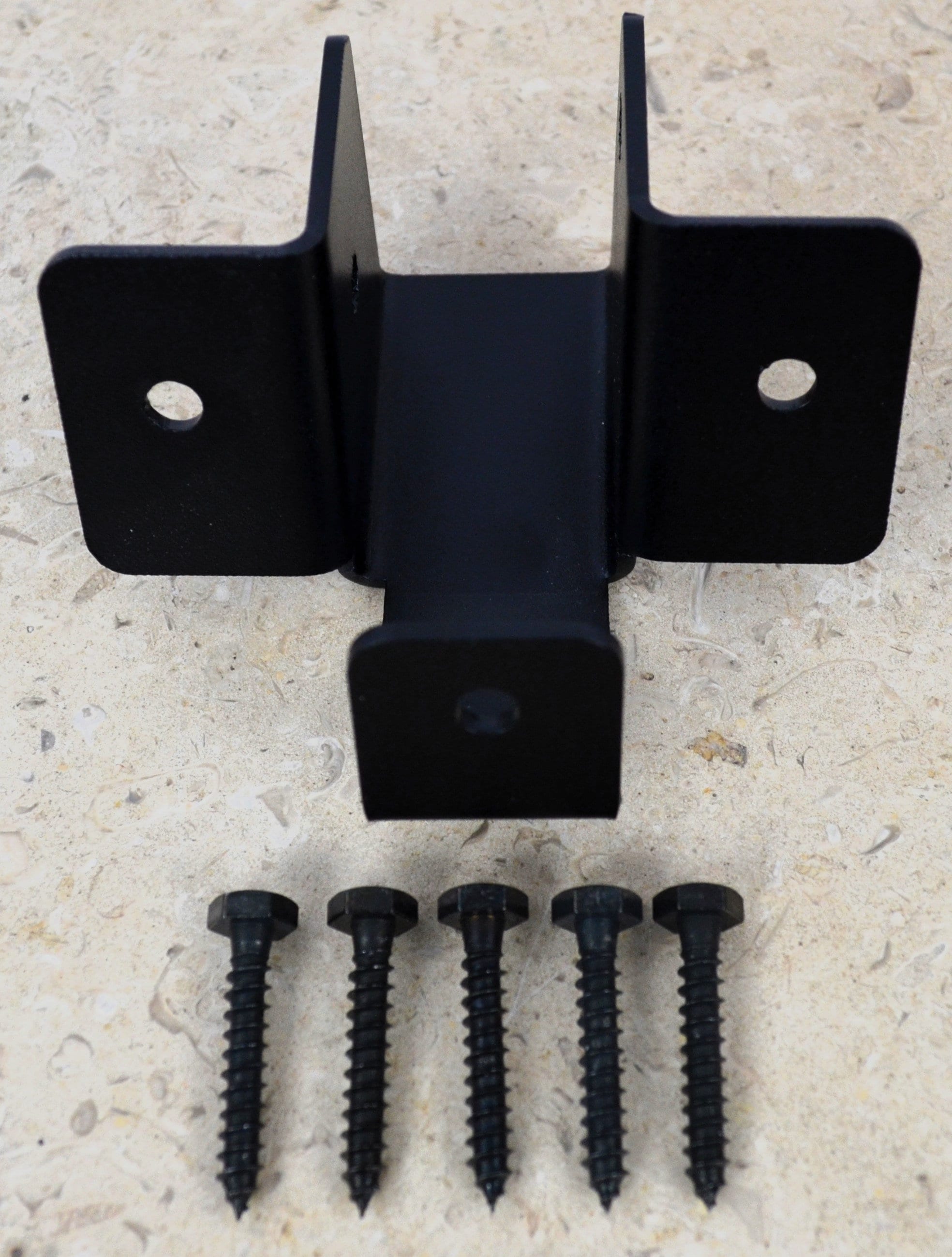 A detailed illustration of a partial octagon ridge rafter skirt tie bracket, including the bracket and four lag screws, ideal for various construction applications.